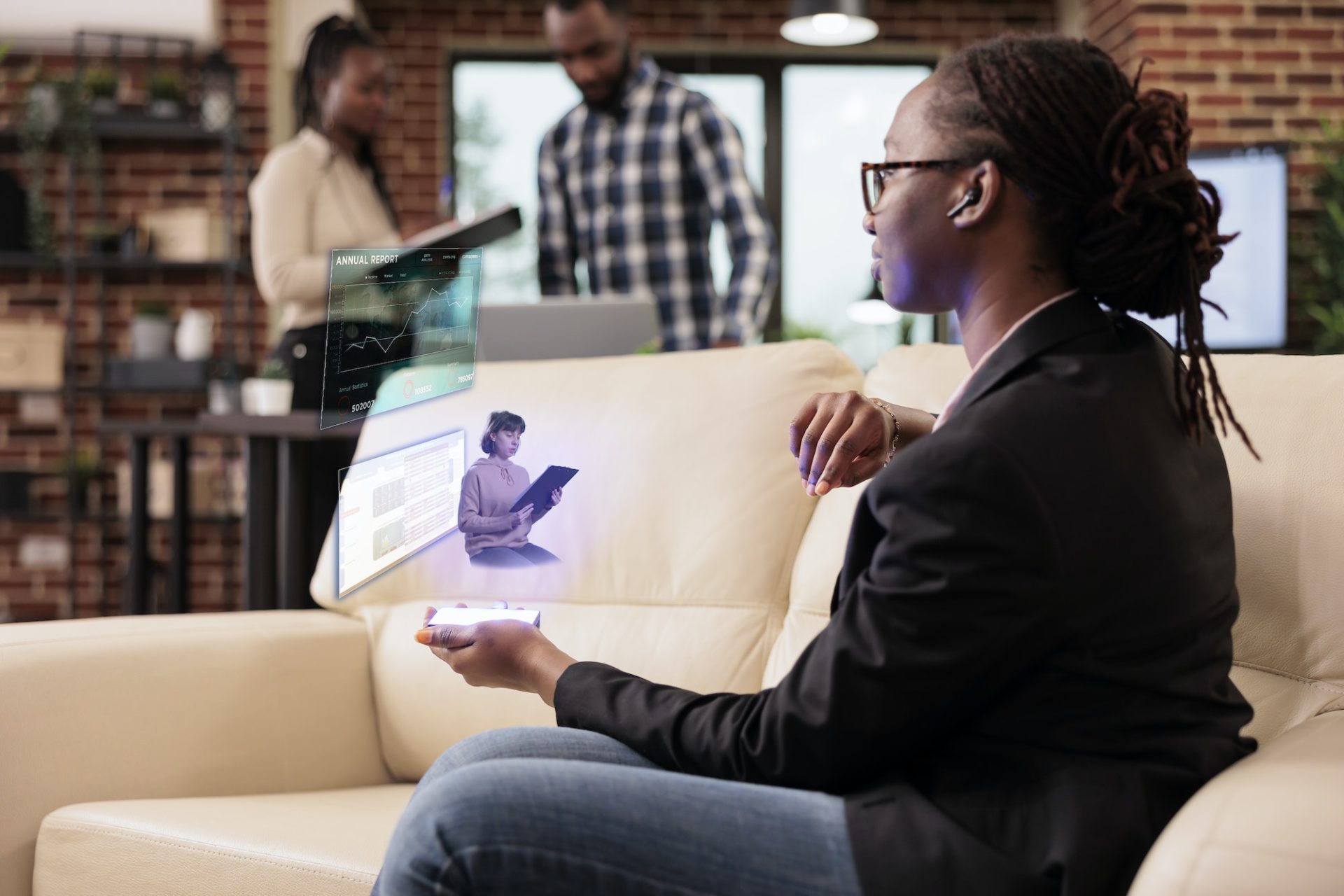 Female employee talking to ai hologram